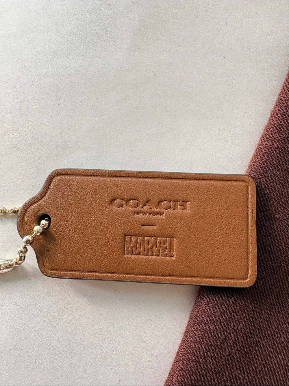 🦸♀️ Coach x MARVEL Ltd Ed Saddle Brown Leather HangTag Bag Charm | 2.375” - Picture 2 of 7